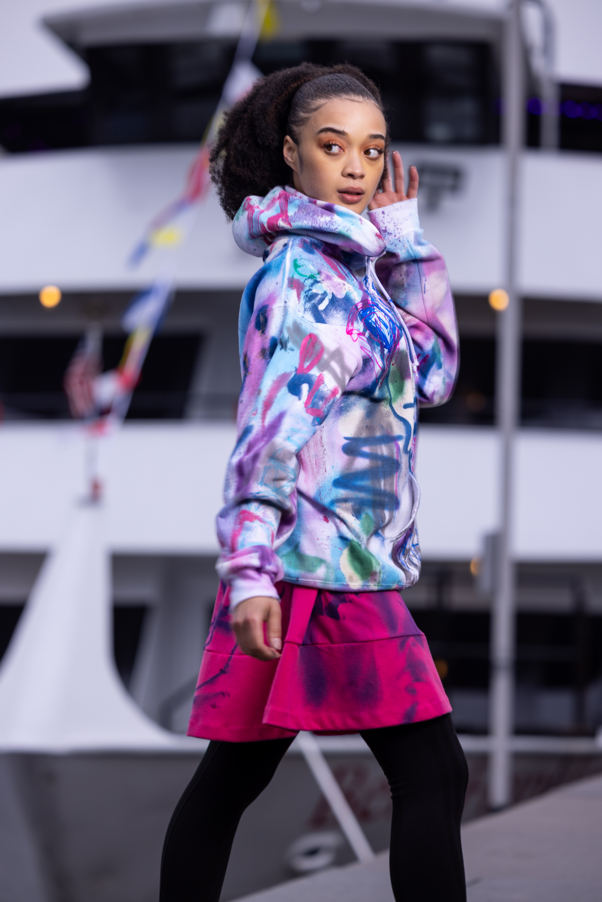 Model posing in a hand-painted DiSoRdInE piece along the Philadelphia riverfront