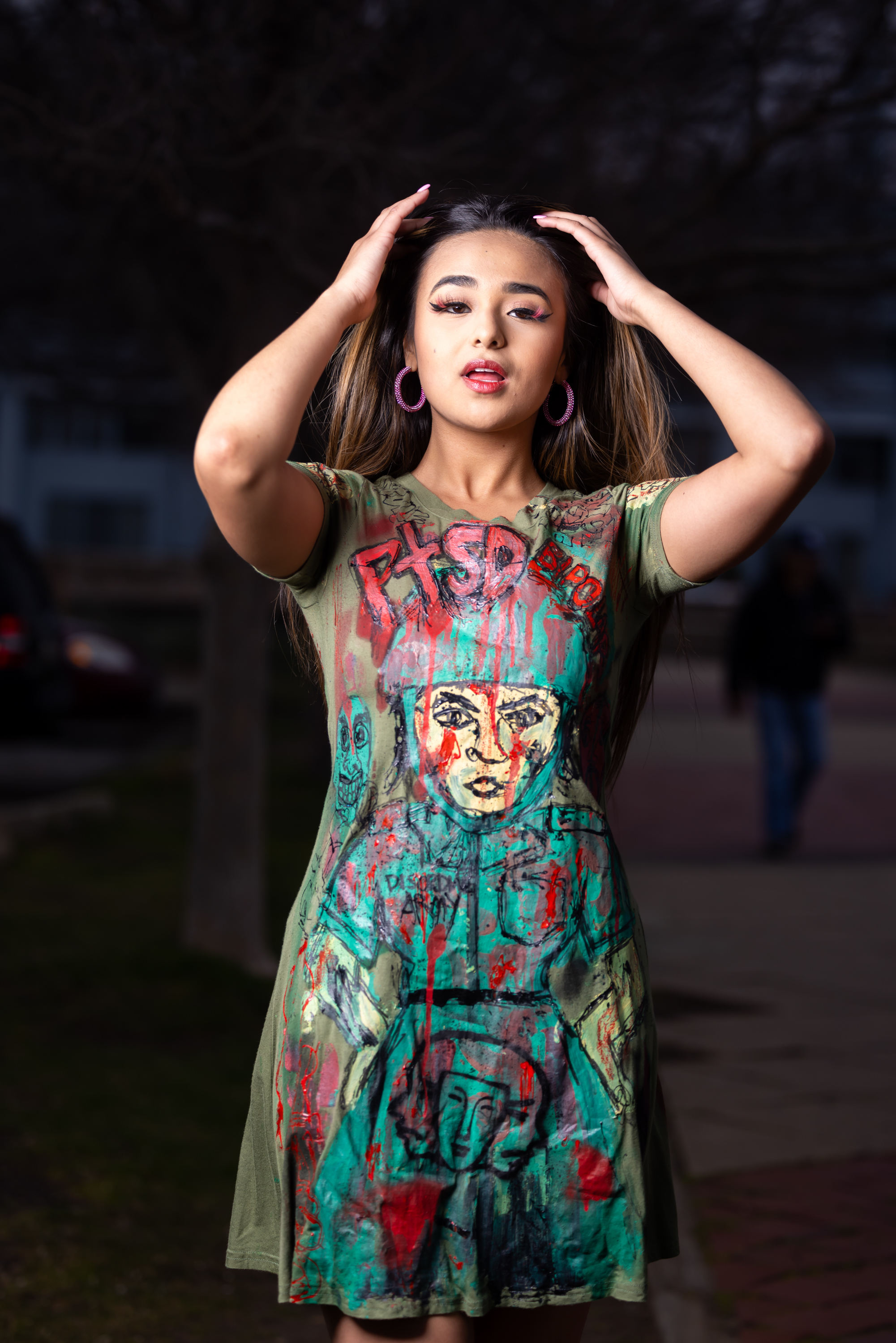 Model showcasing a hand-painted DiSoRdInE original at Penn’s Landing at dusk