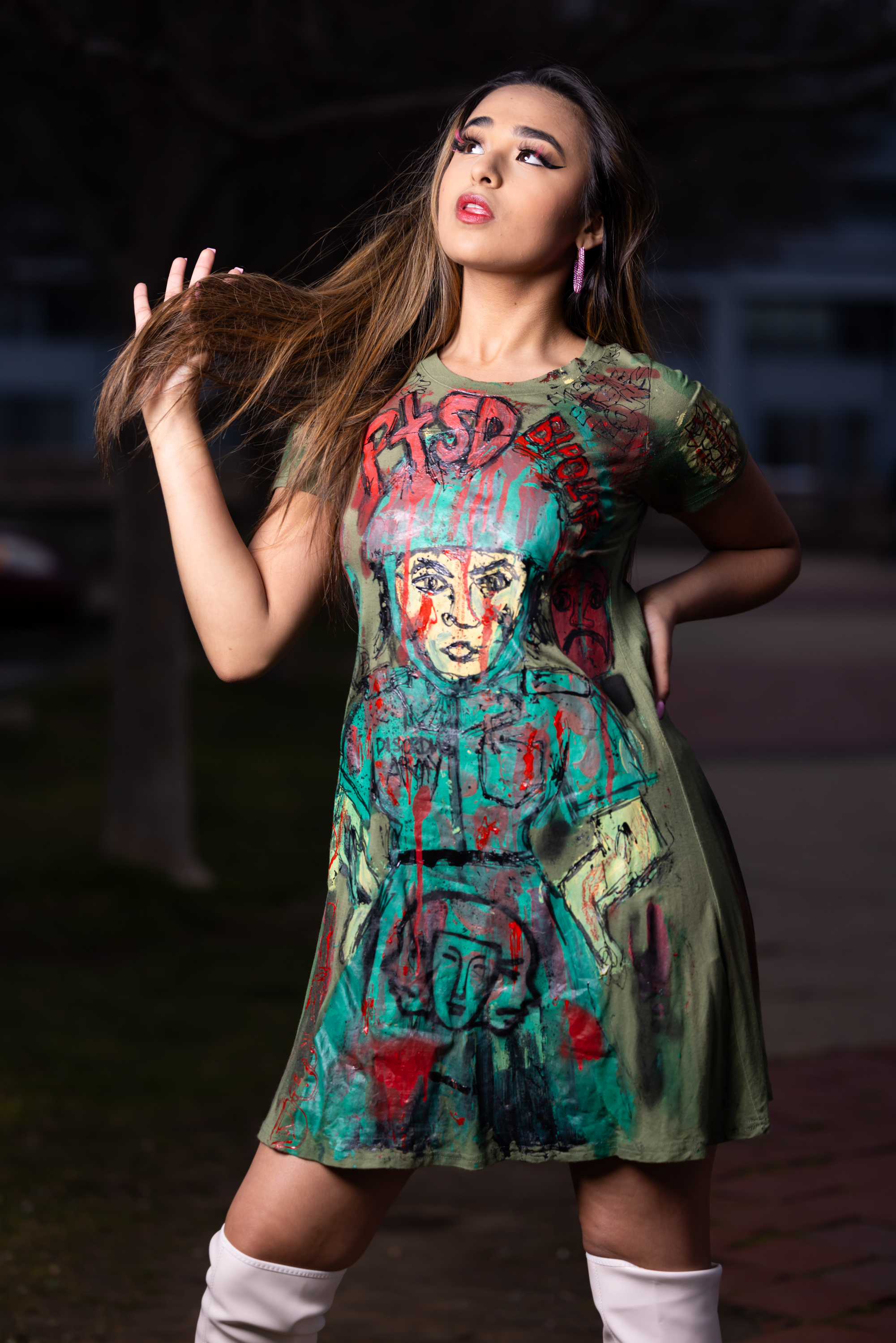 Model showcasing hand-painted DiSoRdInE apparel at the waterfront at dusk